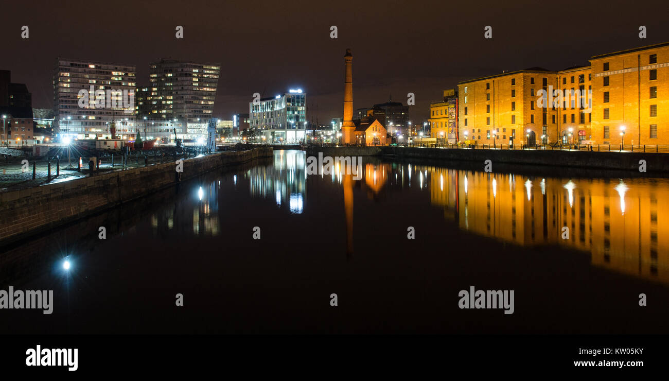Liverpool, England, UK - November 4, 2014: The pump house and warehouses of the historic Albert Dock complex are reflected in Canning Dock in Liverpoo Stock Photo