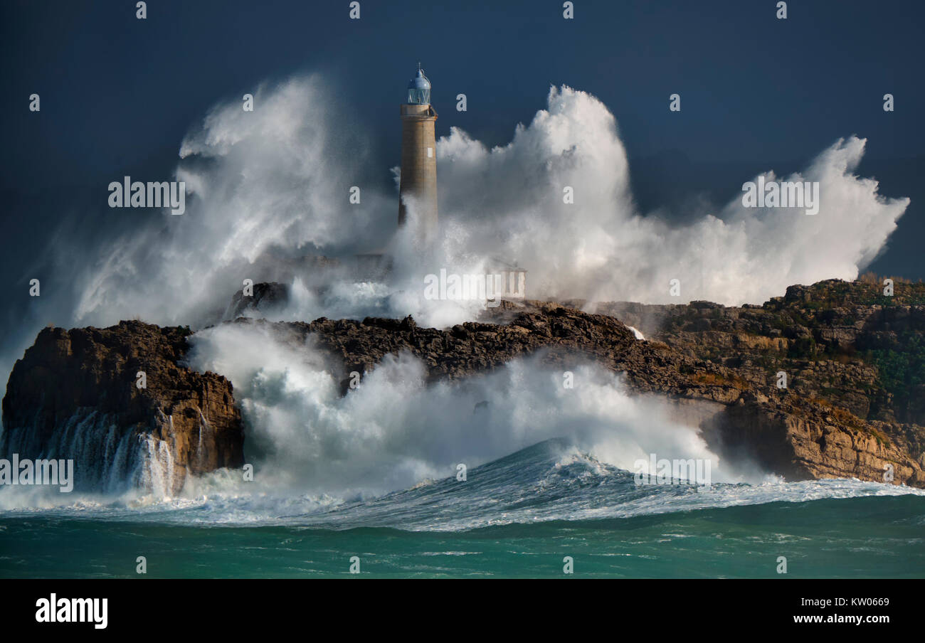 The Mouro island lighthouse during a storm. Big waves, more of 10 meters. Santander, Spain. Stock Photo