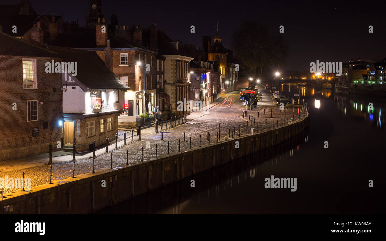York, England, UK - January 28, 2017: Traditional houses and the King's Arms pub line the cobbled quayside of the River Ouse in York at night. Stock Photo