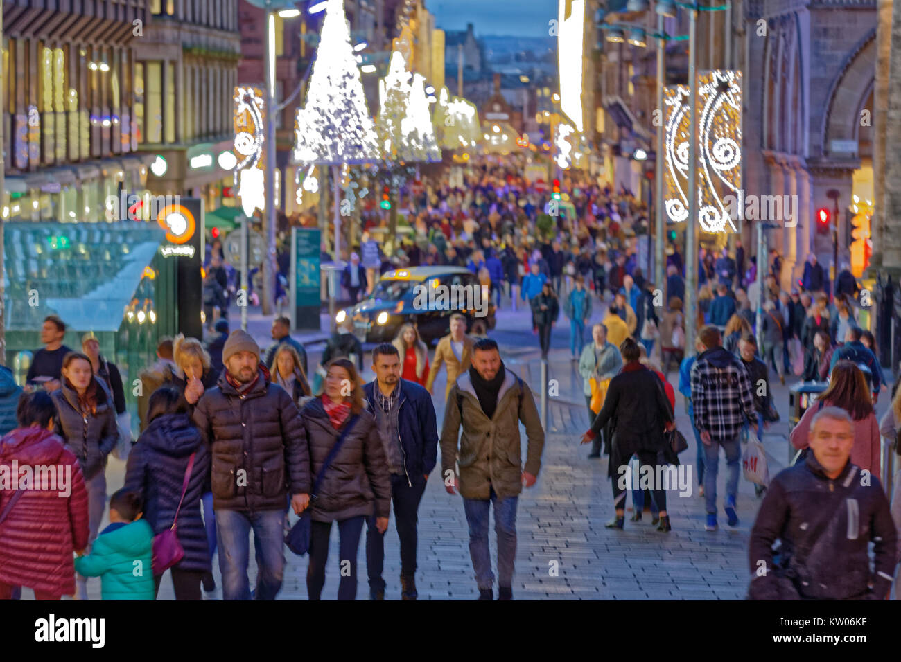 Christmas decorations on Buchanan street the style mile with crowds of shoppers shopping Stock Photo