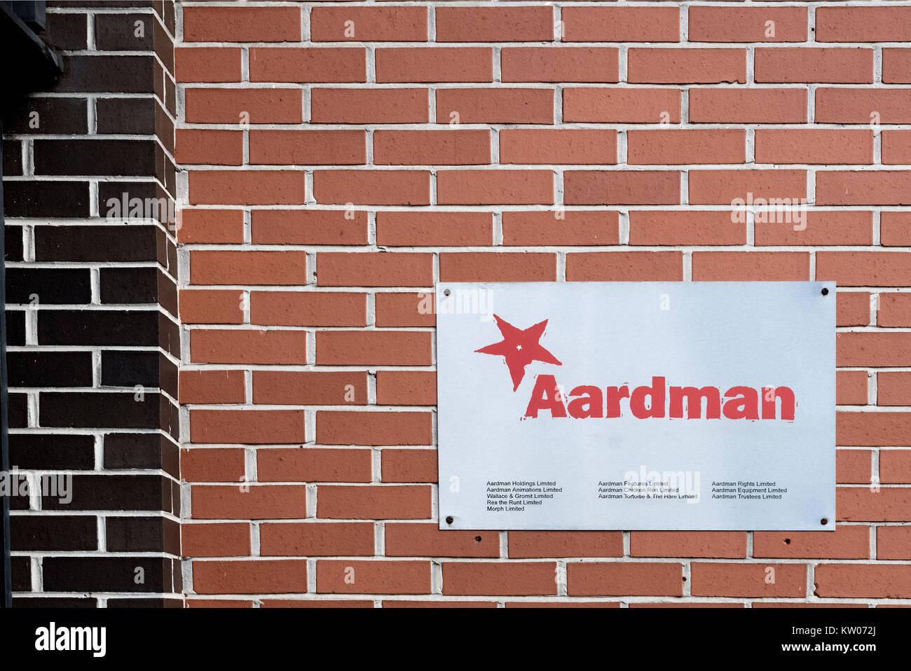 A metal wall plate for Aarman animations on the office wall outside the entrance to their business premises in Bristol, England Stock Photo