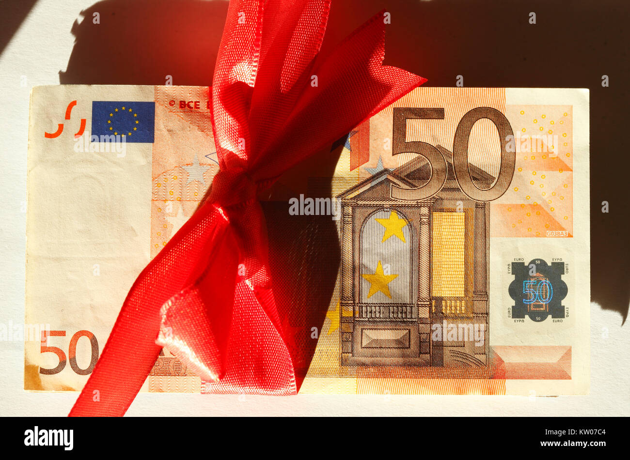 Fifty Euros Banknote with red loop as gift of money Stock Photo