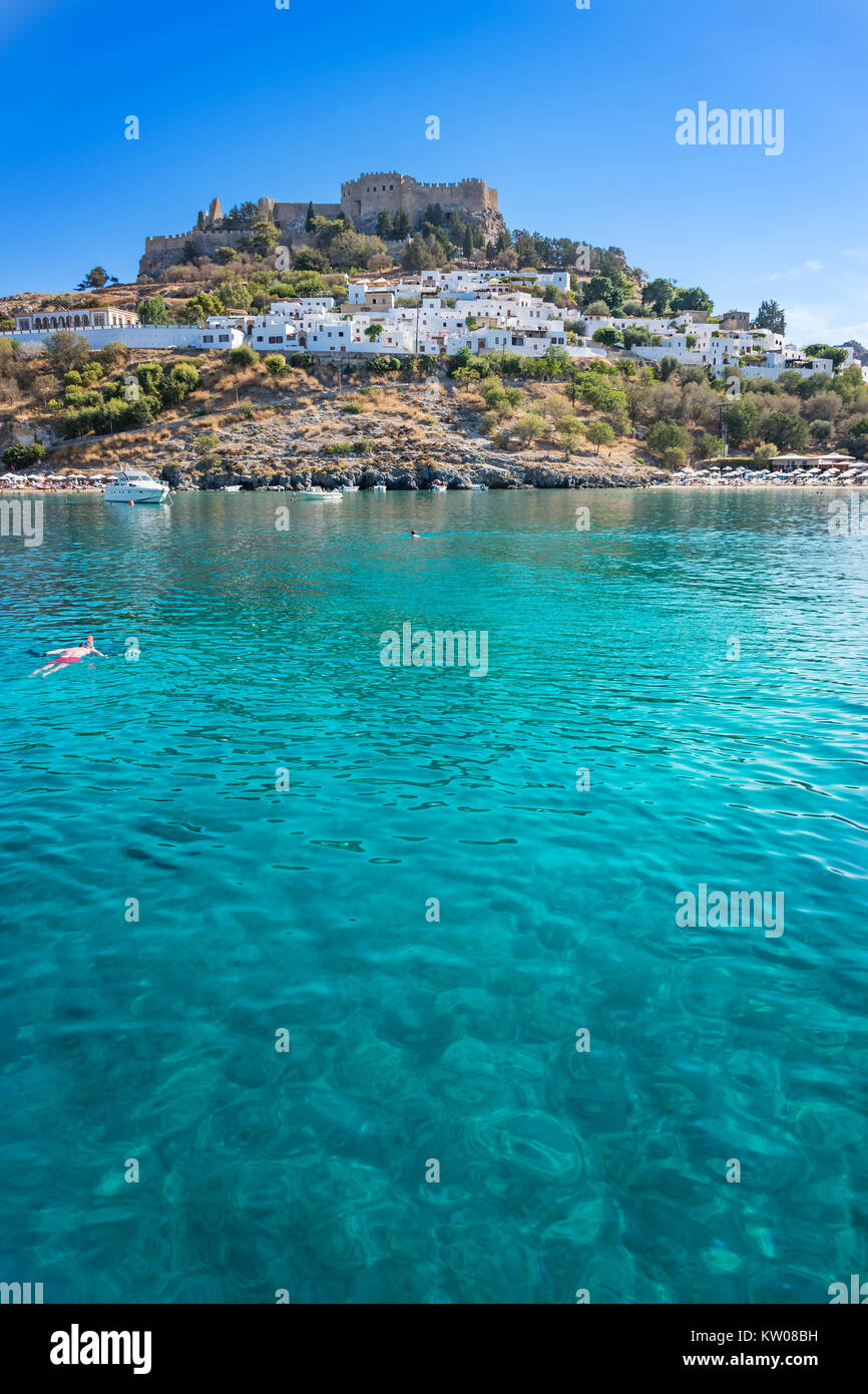 Bay of Lindos and acropolis of Lindos in background (Rhodes, Greece) Stock Photo