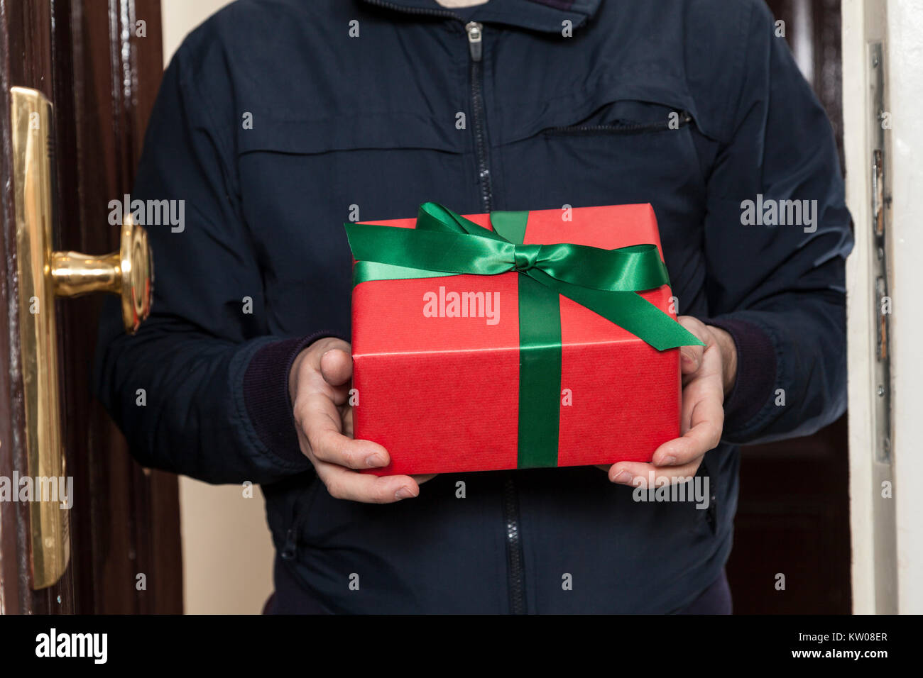 Postman brings a christmas present Stock Photo Alamy