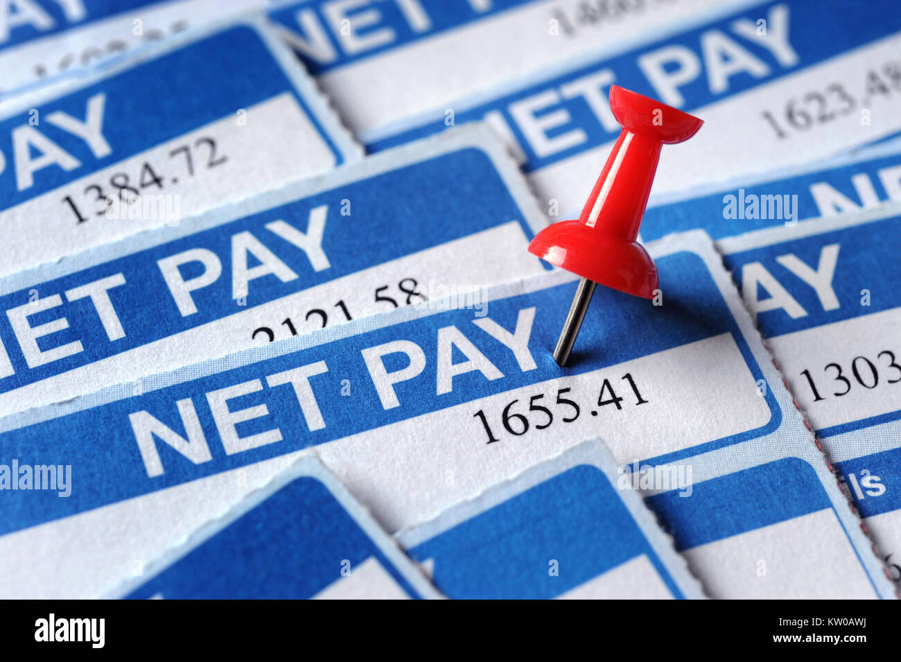 PAYSLIPS WITH RED NOTICEBOARD PIN RE WAGES INCOME PENSIONS NET PAY DISPOSABLE INCOME UK Stock Photo