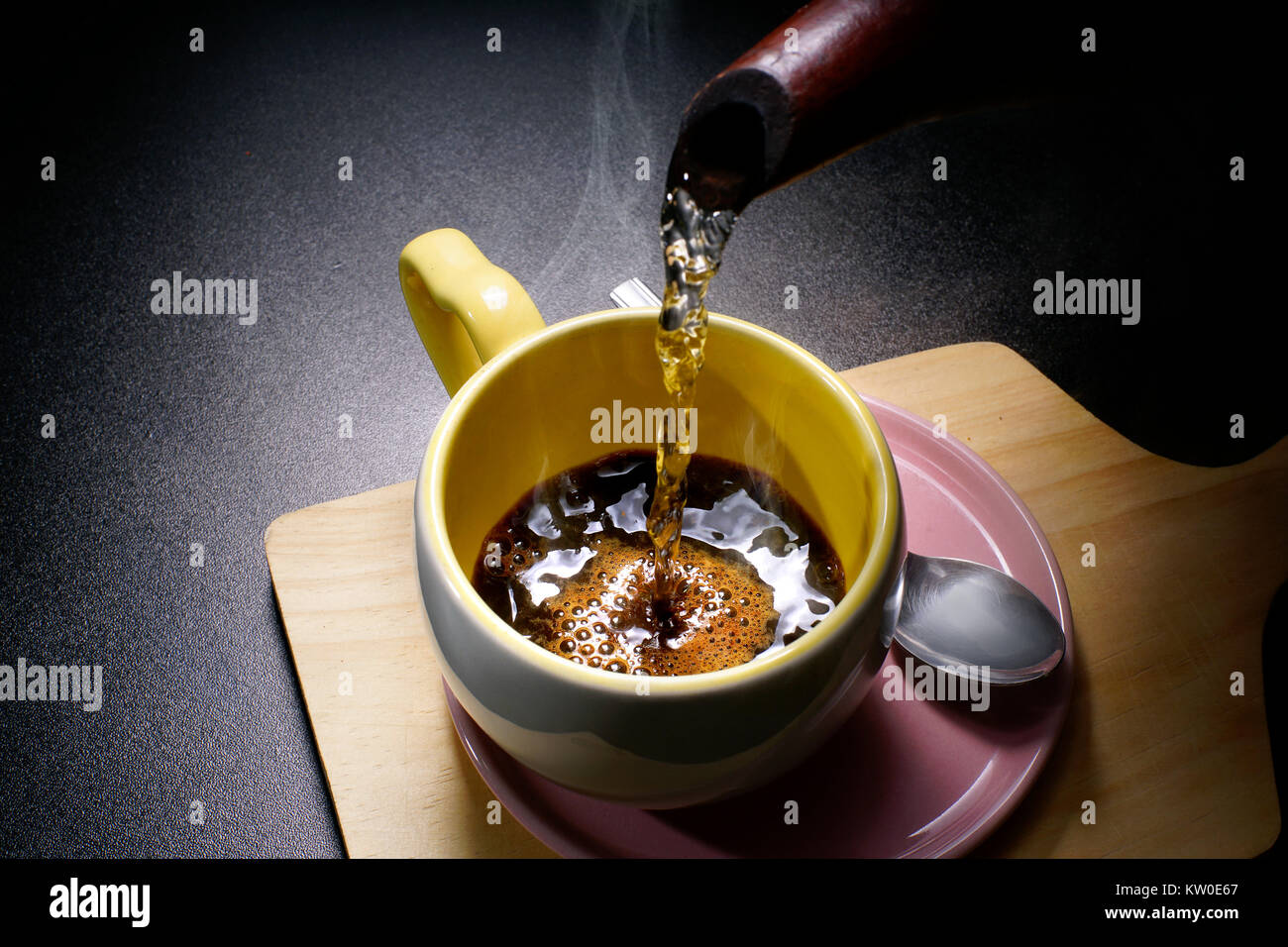 Pouring hot coffee into a cup Stock Photo Alamy