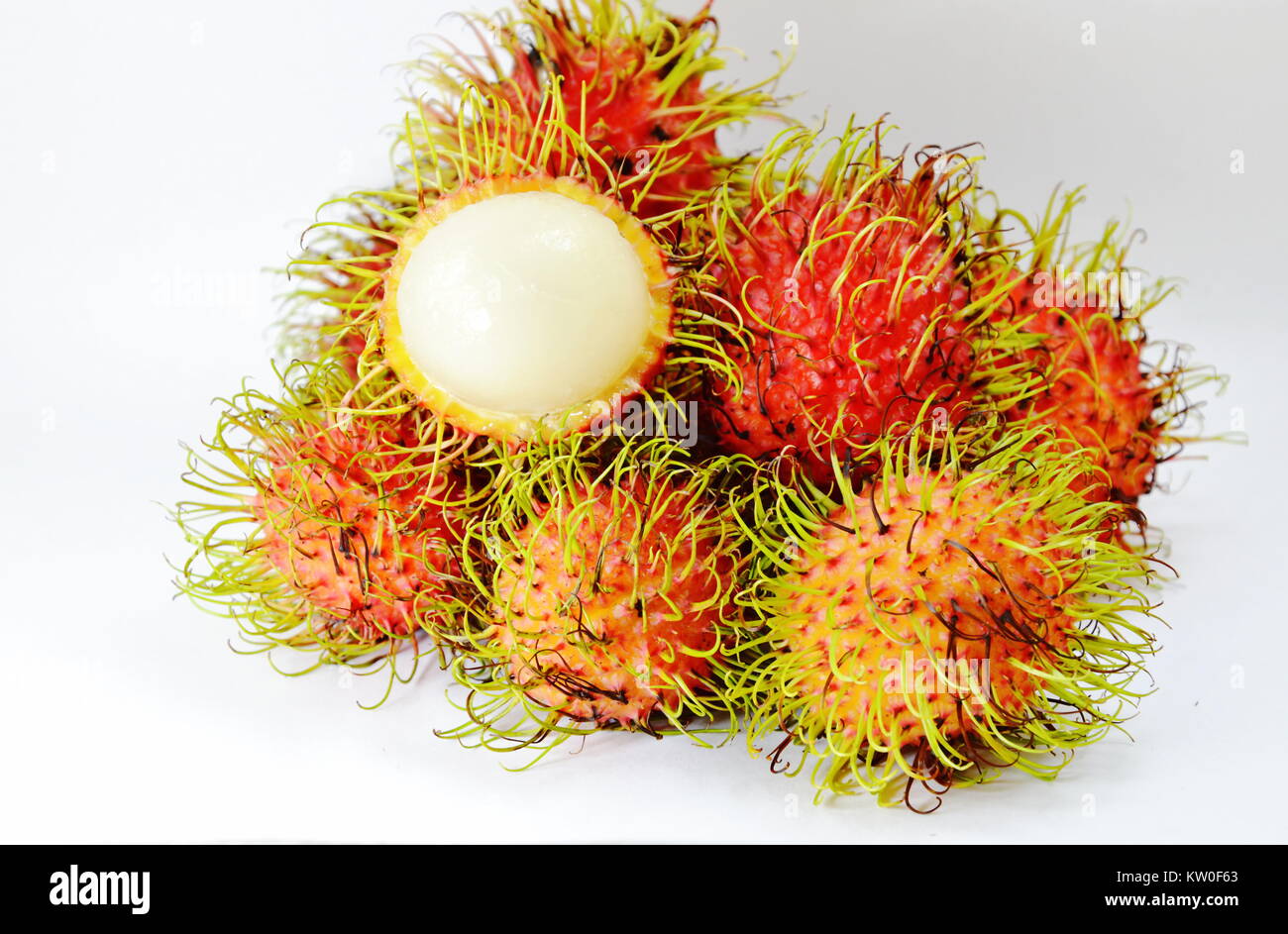 rambutan tropical fruit peel out on white background Stock Photo - Alamy
