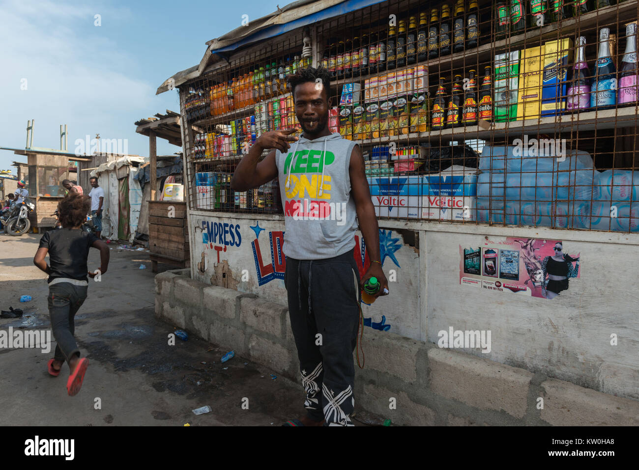 Young Man posing in front of a shop, Jamestown Fishing Village, Jamestown, Accra, Ghana Stock Photo