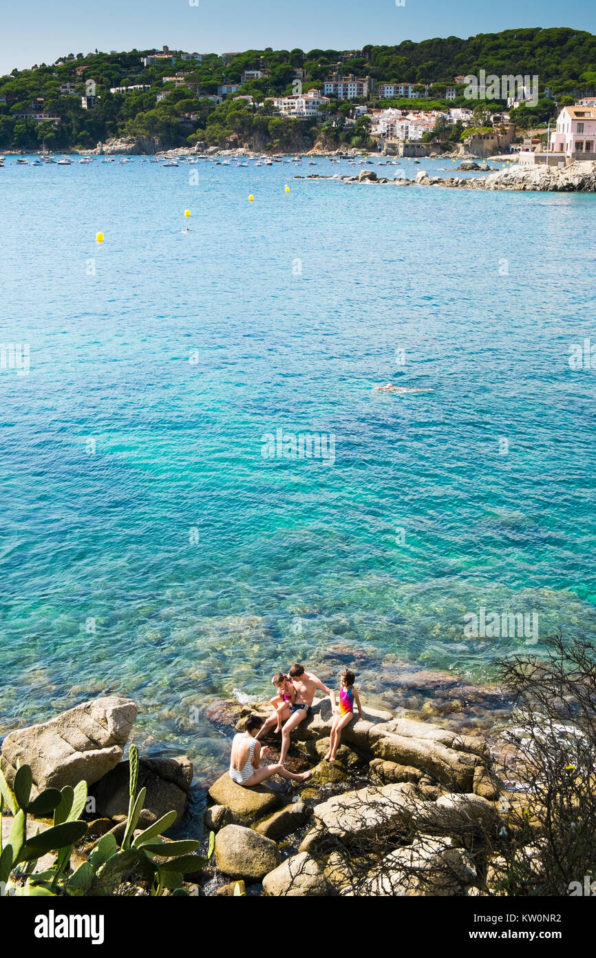 A young family enjoys a visit to the calm waters of the Costa Brava near the town of Calella de Palafrugell, Spain Stock Photo