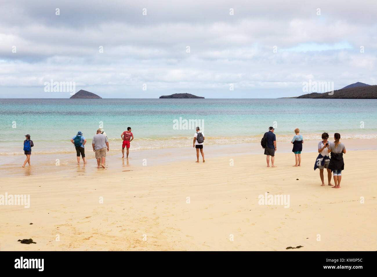 Galapagos beach - tourists on the beach, Floreana Island, Galapagos Islands, Ecuador South America Stock Photo