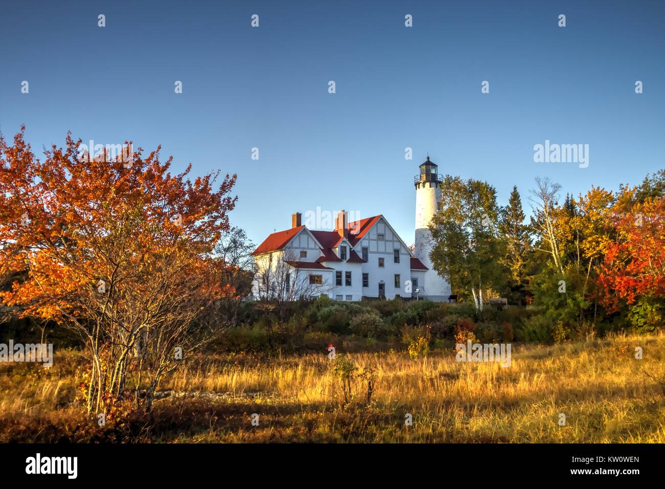 Michigan Autumn Lighthouse. The Point Iroquois Lighthouse with autumn foliage on Lake Superior in the Hiawatha National Forest of the Upper Peninsula Stock Photo