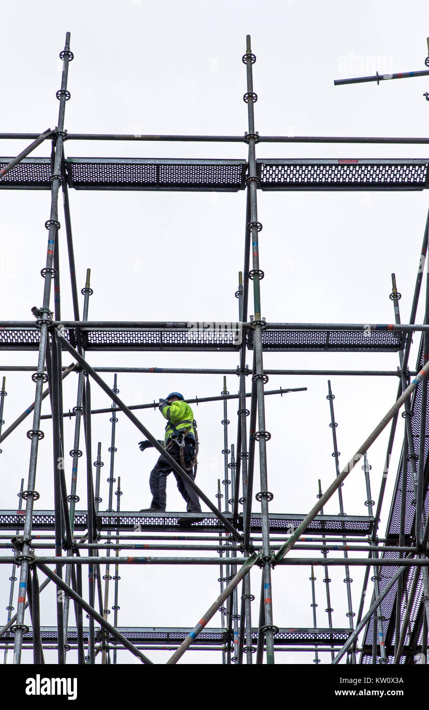 Scaffolders at work, building a large scaffolding, work at high altitude, Stock Photo