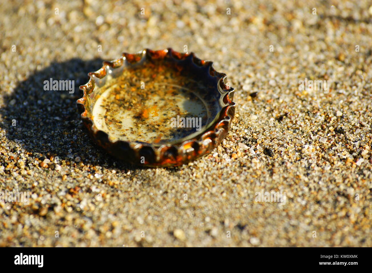 Bottlecap on Sand Stock Photo