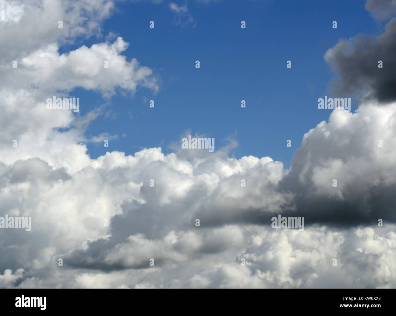 White fluffy clouds in a bright blue sky Stock Photo - Alamy