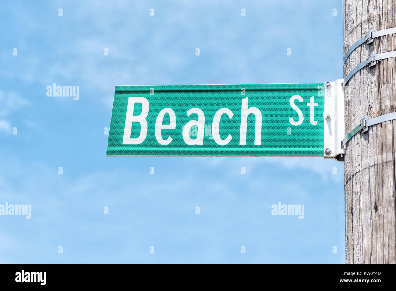 Closeup of Beach street sign attached on pole isolated against blue sky background Stock Photo