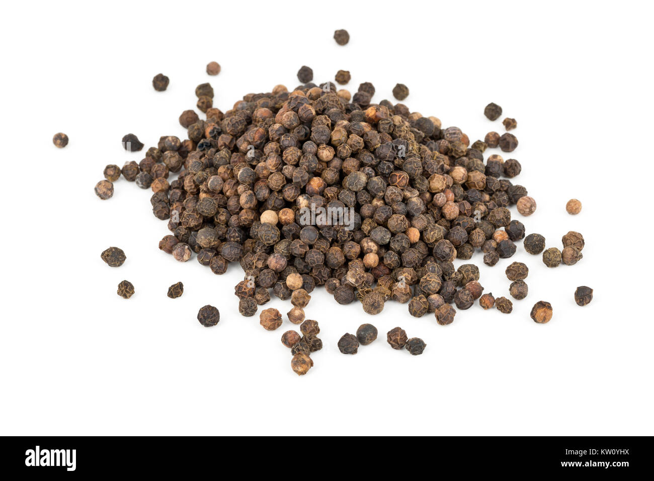 Heap of raw, natural, unprocessed black pepper peppercorns over white background Stock Photo