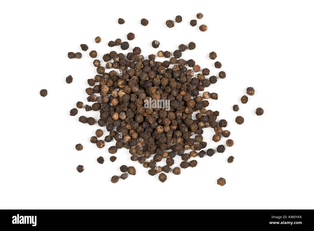 Heap of raw, natural, unprocessed black pepper peppercorns over white background Stock Photo
