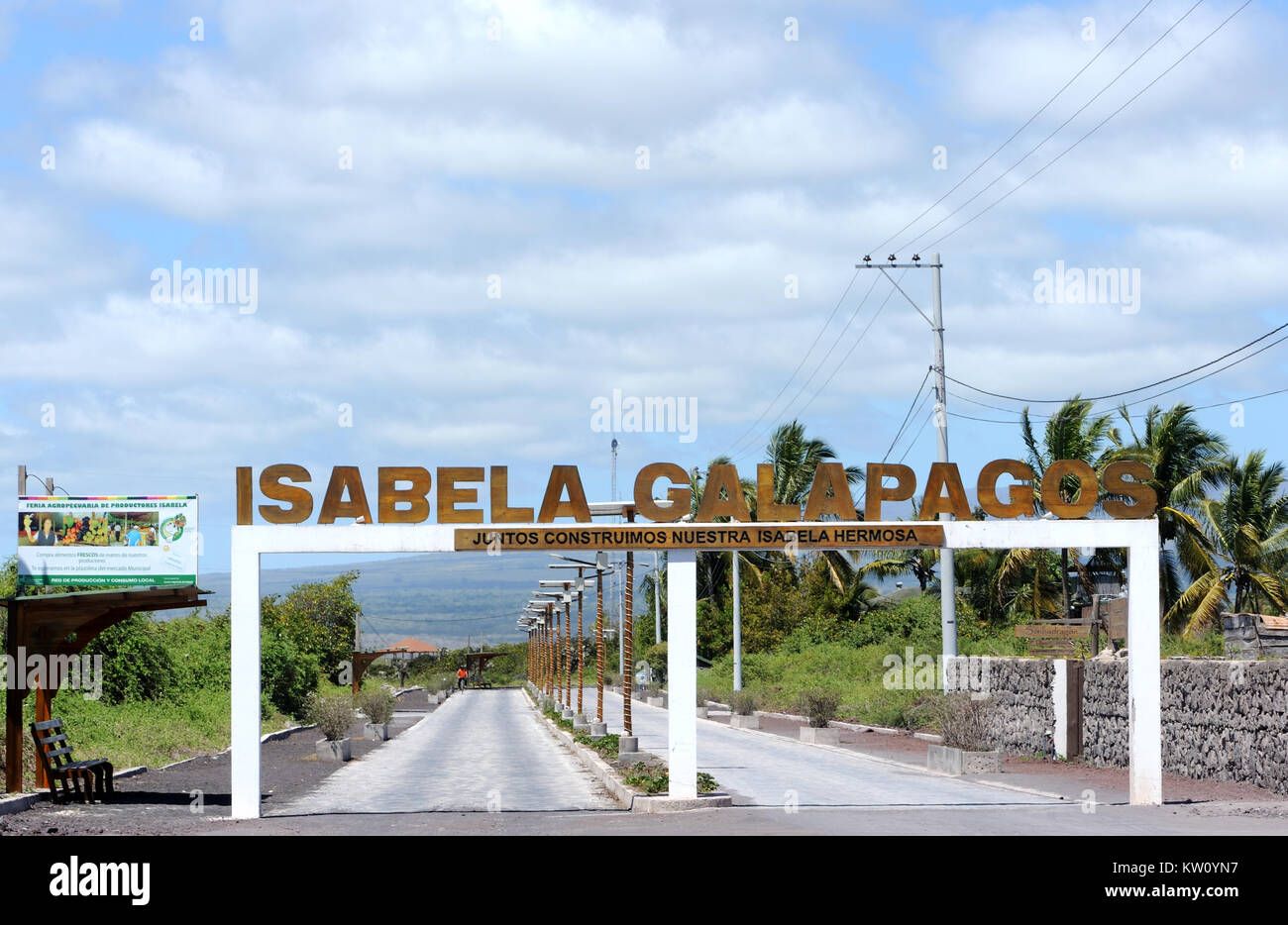 New paved section of the road between the jetty at Playa Isabela and Puerto Villamil. There is an arch with the words ‘Isabela Galapagos. Juntos Const Stock Photo