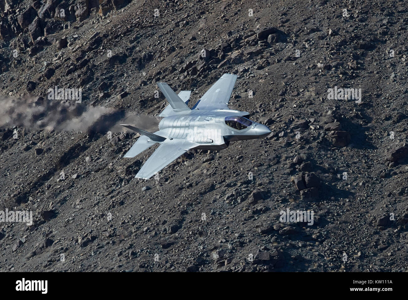 Lockheed Martin F-35A Lightning II Joint Strike Fighter (Stealth Jet Fighter), Flying At Low Level Through A Desert Valley In California, USA. Stock Photo