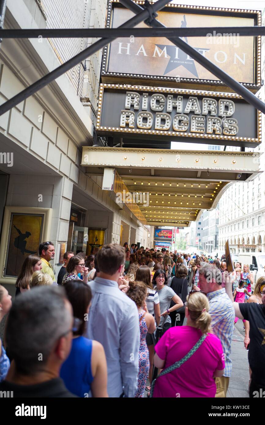Before a performance of the Broadway musical Hamilton two days prior to creator Lin Manuel Miranda's departure from the show, fans stand in line and wait to enter the Richard Rodgers theatre, New York City, New York, July 7, 2016. Stock Photo