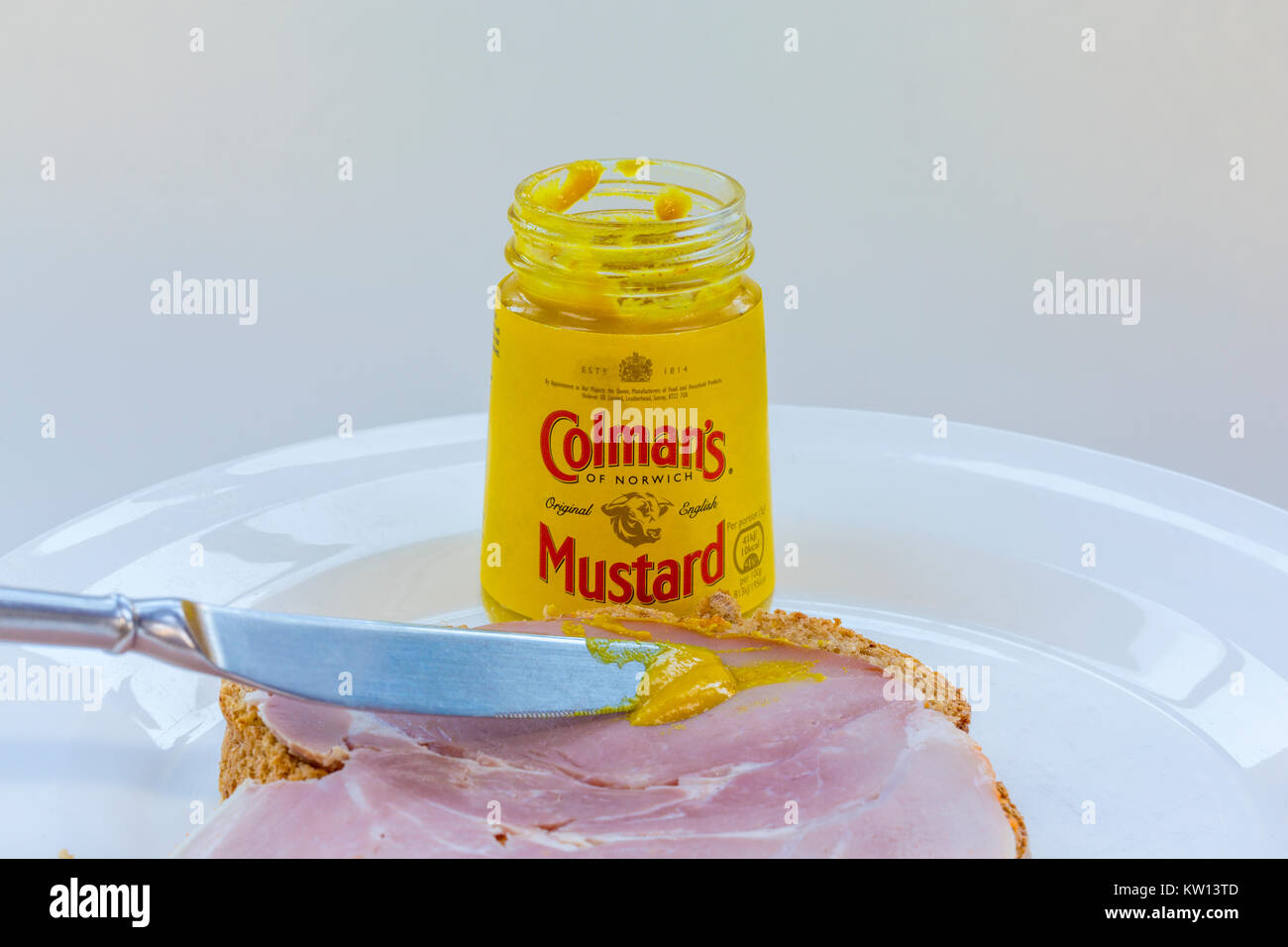 Jar of Colman's mustard made in Norwich, Norfolk, with bread and ham