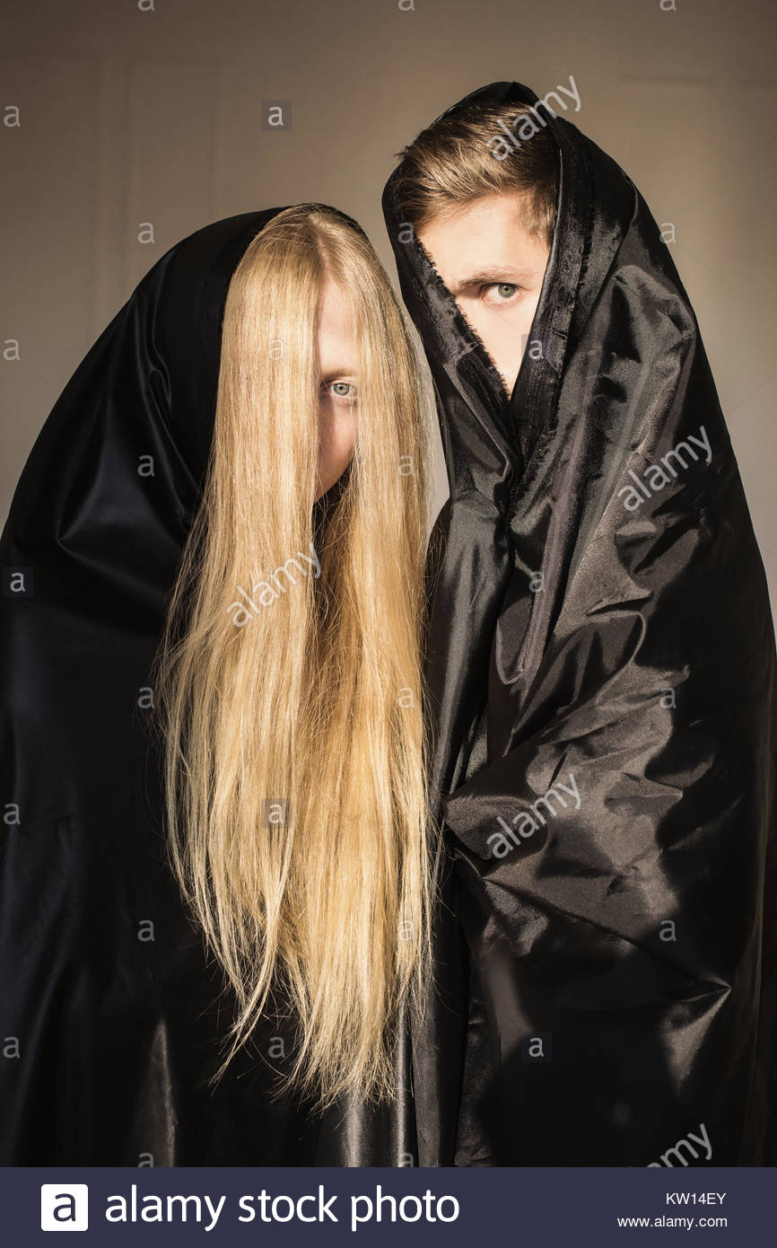 The Girl With Long Blonde Hair And A Man In Black Cloth On Faces