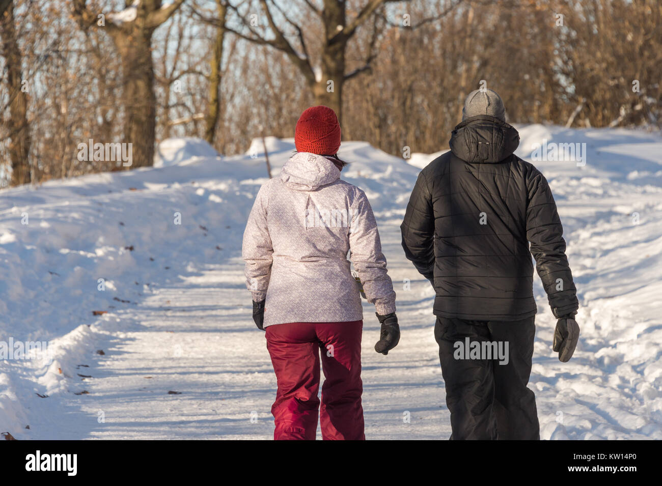 Montreal, CA - 26 December 2017: Couple walking on a snowy trail in Montreal's Mount Royal Park (Parc Du Mont-Royal) Stock Photo