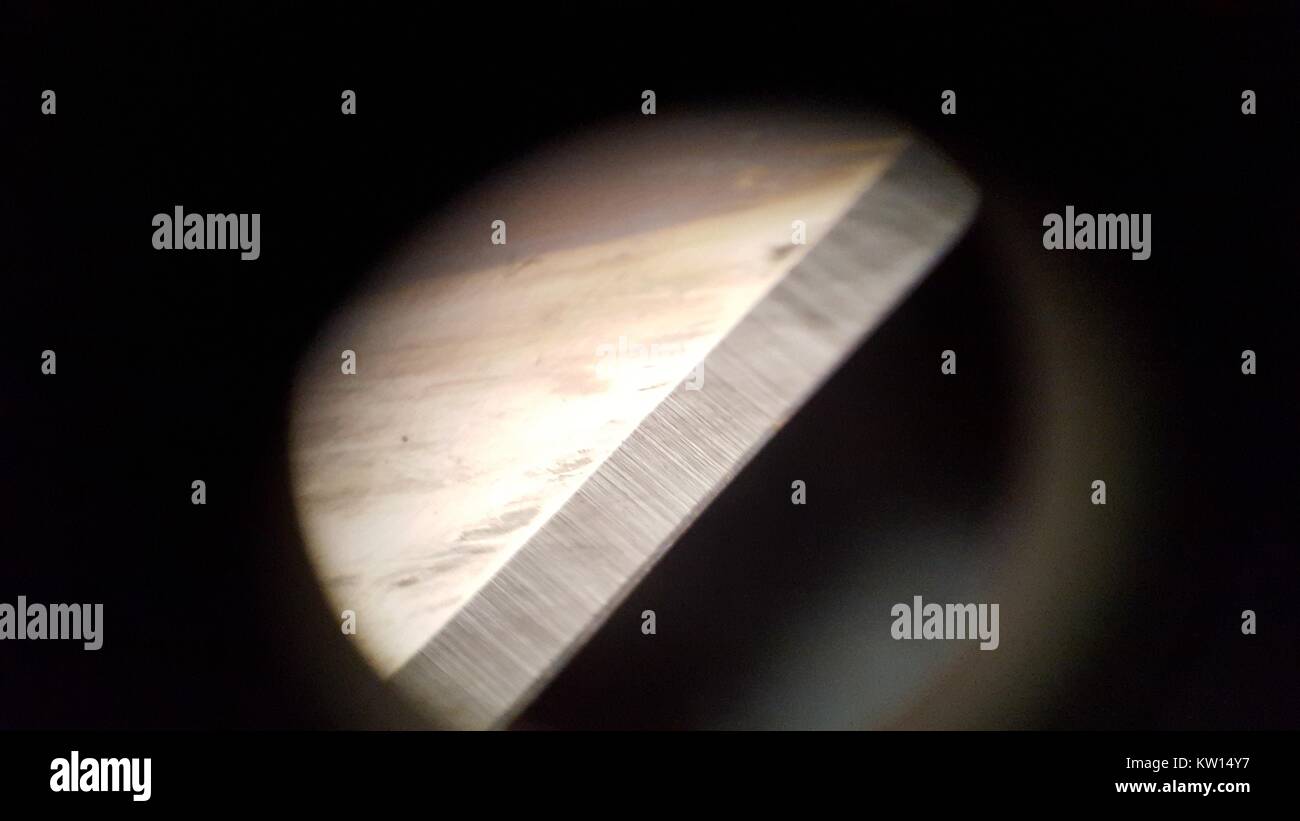 Light microscope image at approximately 30x magnification showing the edge of a razor blade, 2016. Stock Photo