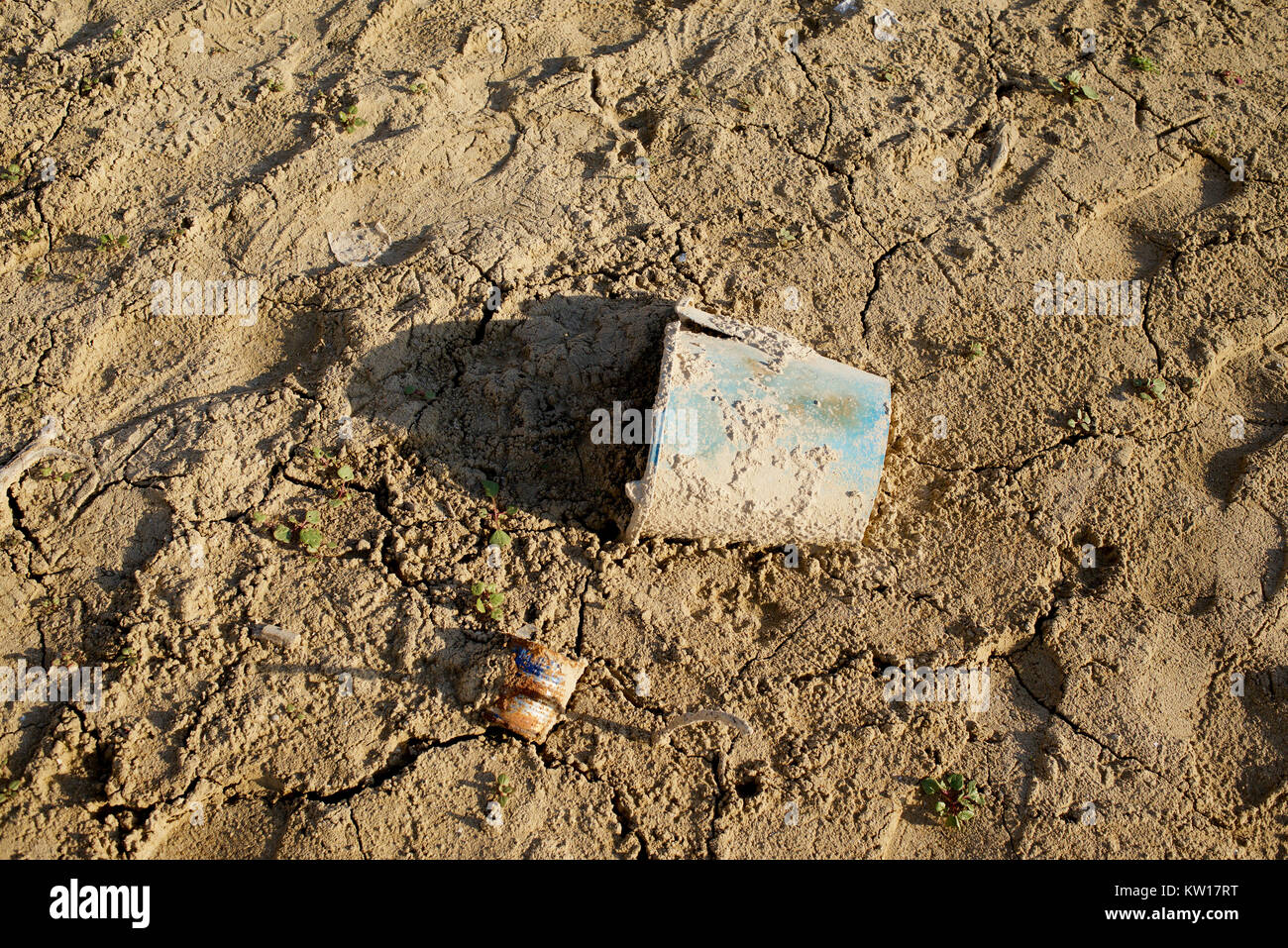 Bucket in the mud of a low level reservoir Stock Photo Alamy