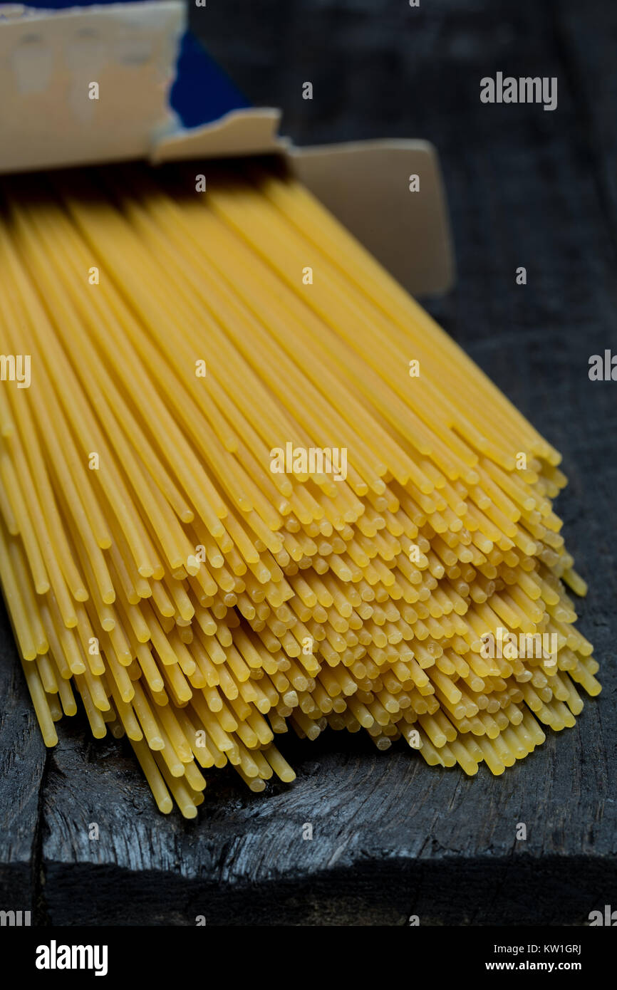 Spaghetti noodle on dark rustic wood Stock Photo Alamy