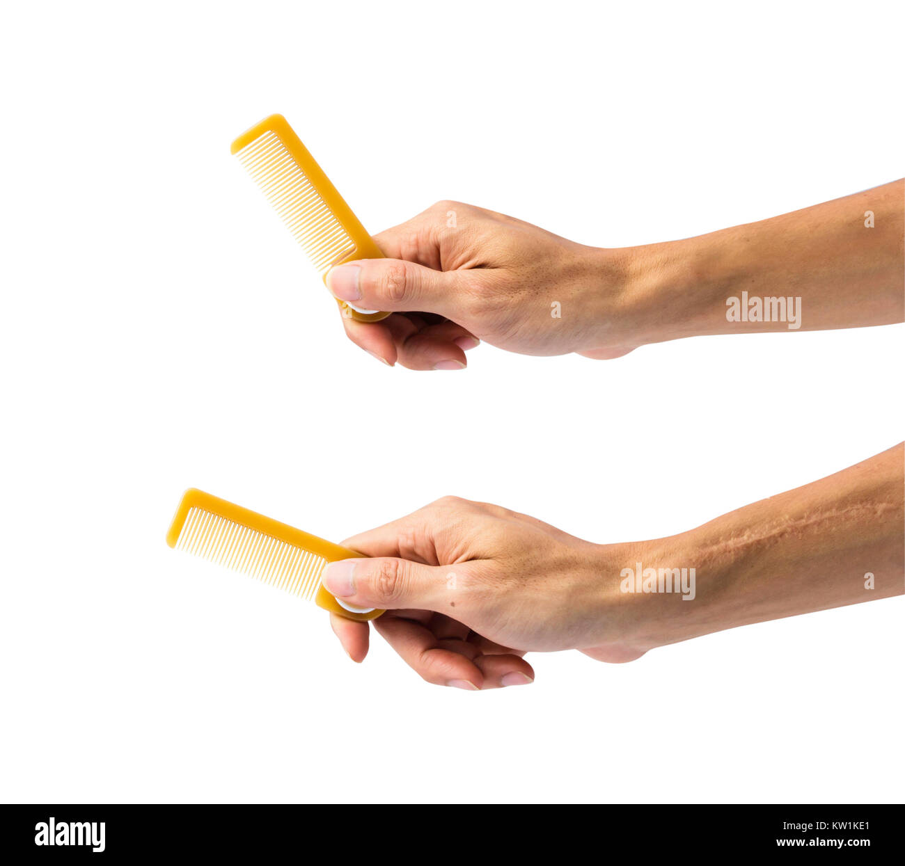 Hand holding comb isolated on white background with clipping path. Stock Photo
