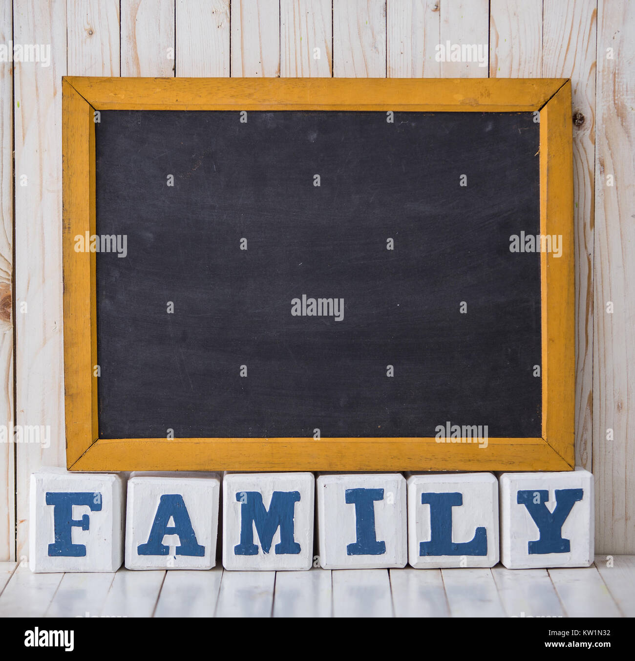 Chalkboard and FAMILY sign made of wooden blocks on wooden backg Stock