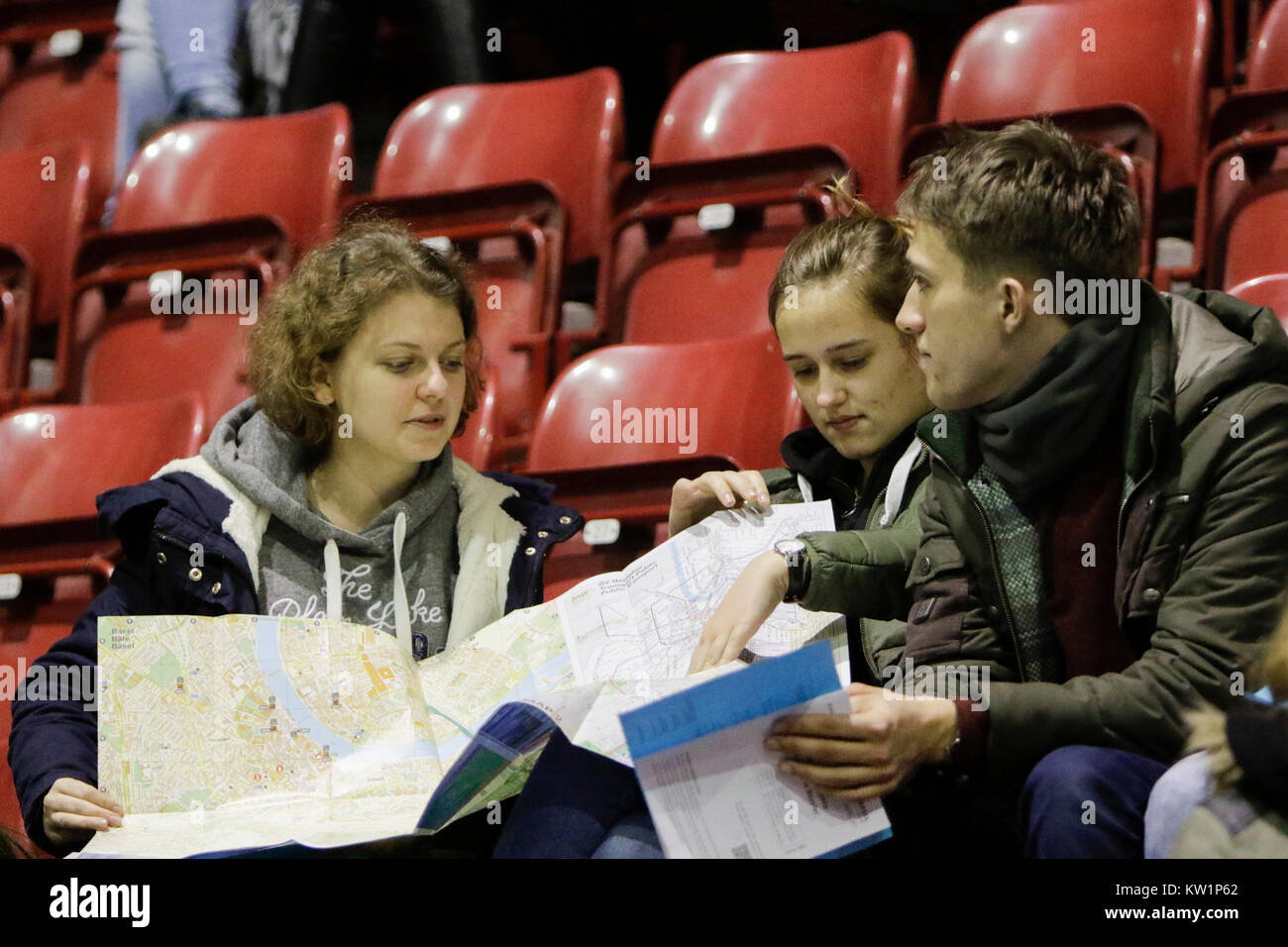Basel, Switzerland. 28th Dec, 2017. Three pilgrims study a map, to see where they have to go, to find the parish they are assigned to. Several thousand young pilgrims from all over Europe and beyond arrived in Basel in Switzerland for the annual European Youth Meeting of the ecumenical Taize community. The meeting of prayers and meditation is held under the motto 'Pilgrimage of Trust on Earth' and is the 40th anniversary meeting. Credit: Michael Debets/Alamy Live News Stock Photo