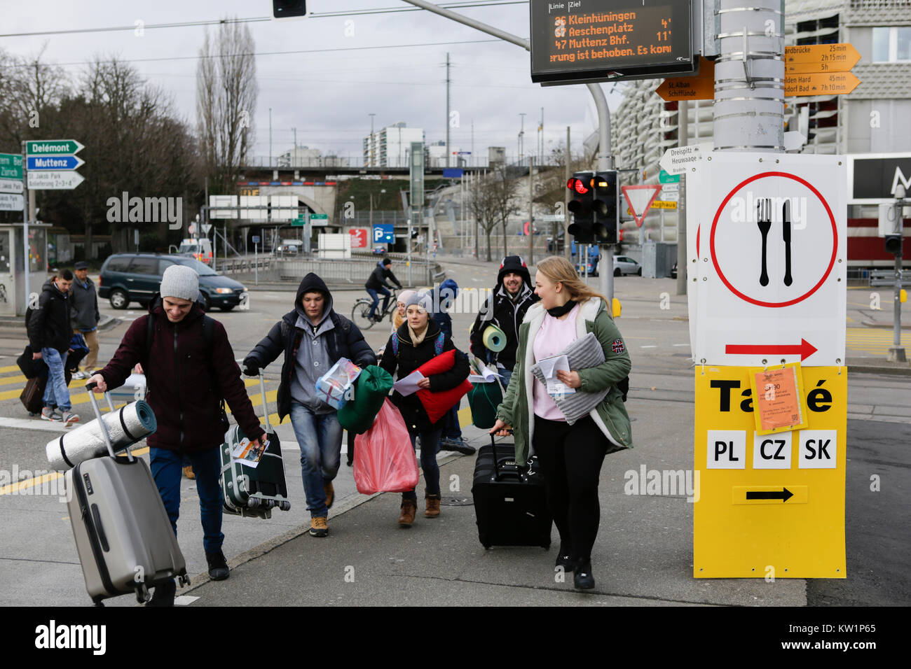 Basel, Switzerland. 28th Dec, 2017. Pilgrims rush to catch the bus, to go to their host parishes. Several thousand young pilgrims from all over Europe and beyond arrived in Basel in Switzerland for the annual European Youth Meeting of the ecumenical Taize community. The meeting of prayers and meditation is held under the motto 'Pilgrimage of Trust on Earth' and is the 40th anniversary meeting. Credit: Michael Debets/Alamy Live News Stock Photo