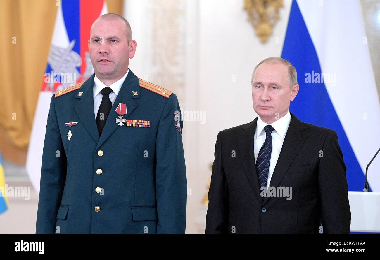 Moscow, Russia. 28th Dec, 2017. Russian President Vladimir Putin stands with Colonel Artur Luft after awarding him the Order of Courage at the State Kremlin Palace December 28, 2017 in Moscow, Russia. Putin meet with service members and presented awards for their service in fighting the Islamic State in Syria. Credit: Planetpix/Alamy Live News Stock Photo