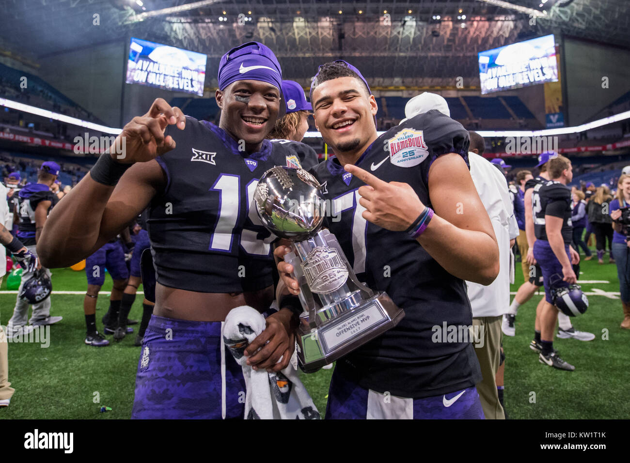 San Antonio, TX, USA. 28th Dec, 2017. TCU Horned Frogs quarterback Kenny Hill (7) holds his Offensive MVP trophy as he celebrates a victory with wide receiver Omar Manning (19) after the Alamo Bowl NCAA football game between the TCU Horned Frogs and the Stanford Cardinal at the Alamodome in San Antonio, TX. TCU won the game 39 to 37. Credit: Cal Sport Media/Alamy Live News Stock Photo