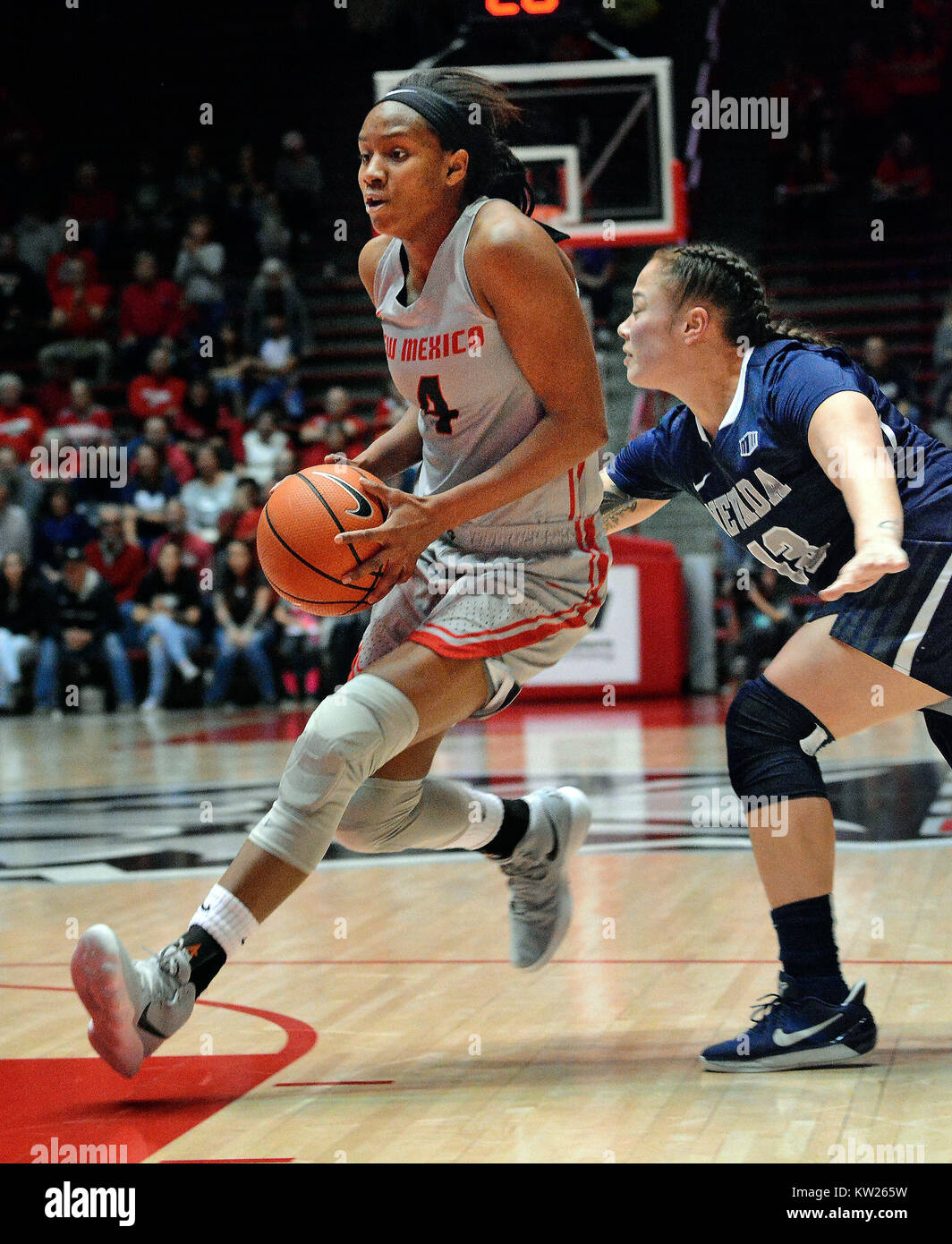 Albuquerque, NM, USA. 30th Dec, 2017. UNM's # 4 Alex Lapeyrolerie drives into the paint against Nevada's # 13 T Moe in their game Saturday afternoon in the Pit. Saturday, Dec. 30, 2017. Credit: Jim Thompson/Albuquerque Journal/ZUMA Wire/Alamy Live News Stock Photo