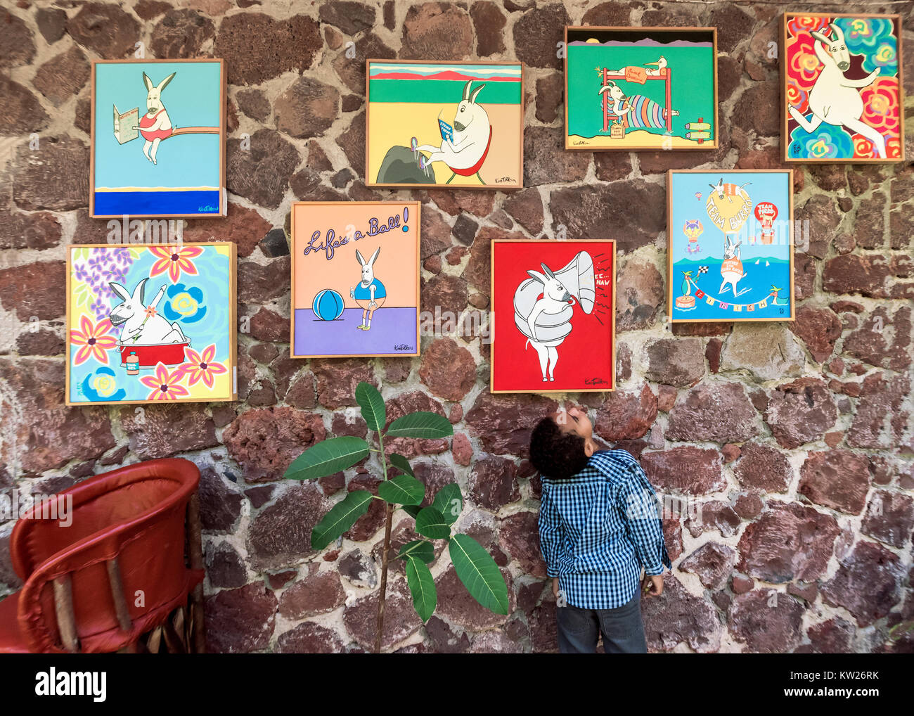 Young art lover admiring the paintings, Yves Restaurant, Ajijic, Mexico Stock Photo