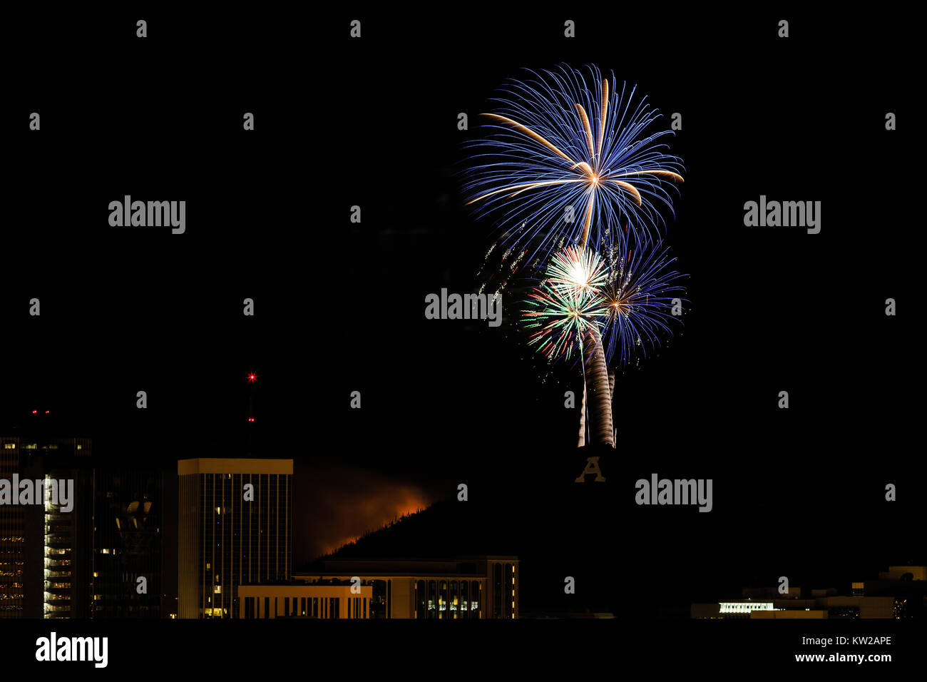 Fireworks light the Tucson sky and light a fire on "A" Mountain for the