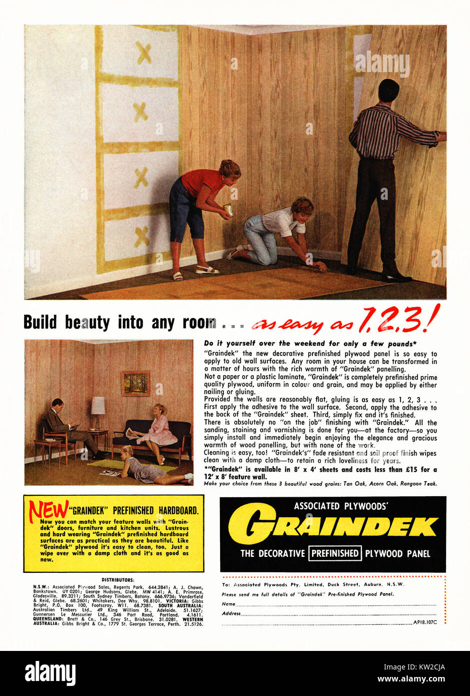 An advert for Graindek decorative wood wall panels - it appeared in an Australian magazine in 1962. The wood look is actually pre-finished, stained and varnished plywood. The photograph shows a family gluing their panels onto the walls - it states that fixing the panels is 'as easy as 1, 2, 3' Stock Photo
