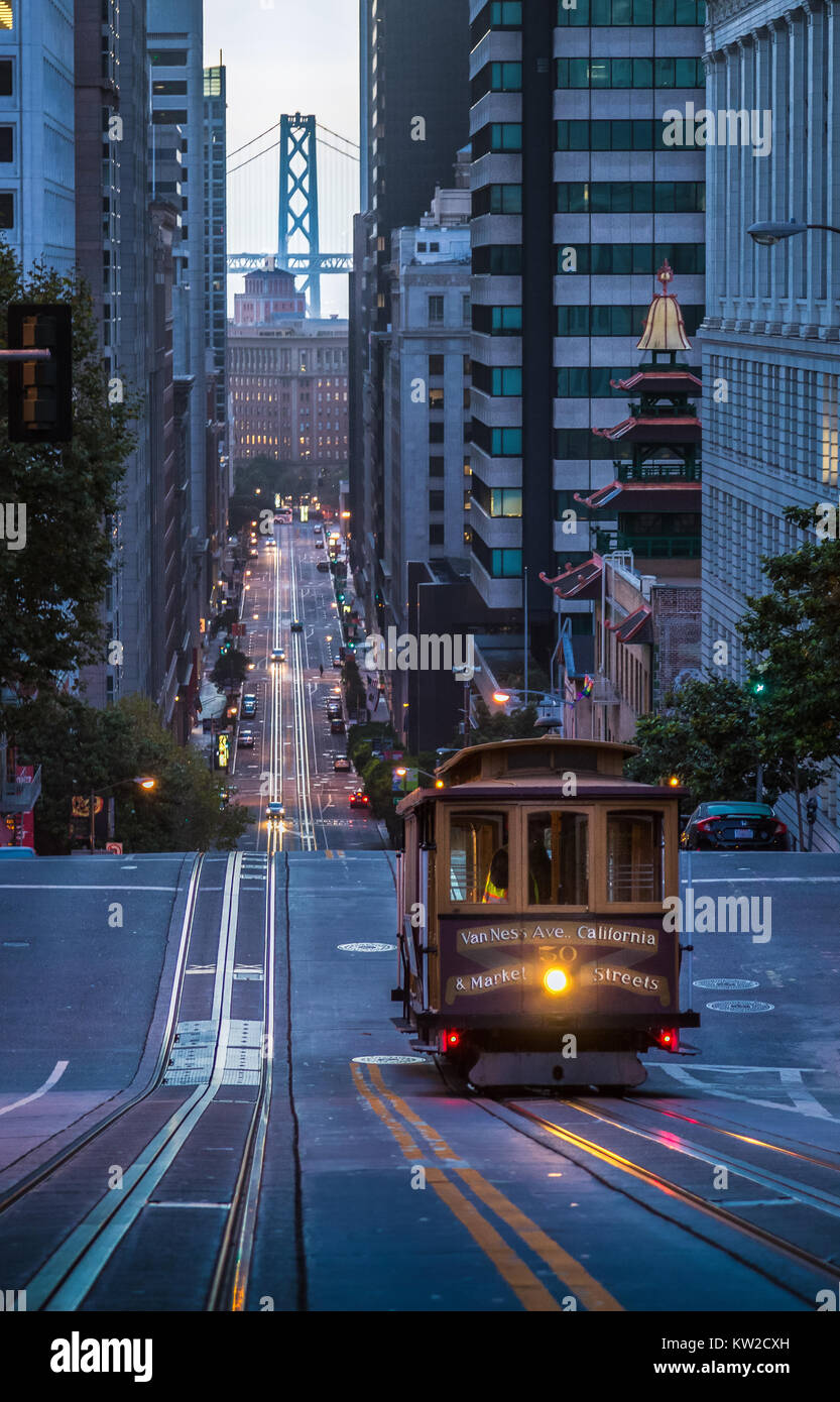 Classic view of historic Cable Car riding on famous California Street in beautiful early morning twilight before sunrise in summer, San Francisco Stock Photo