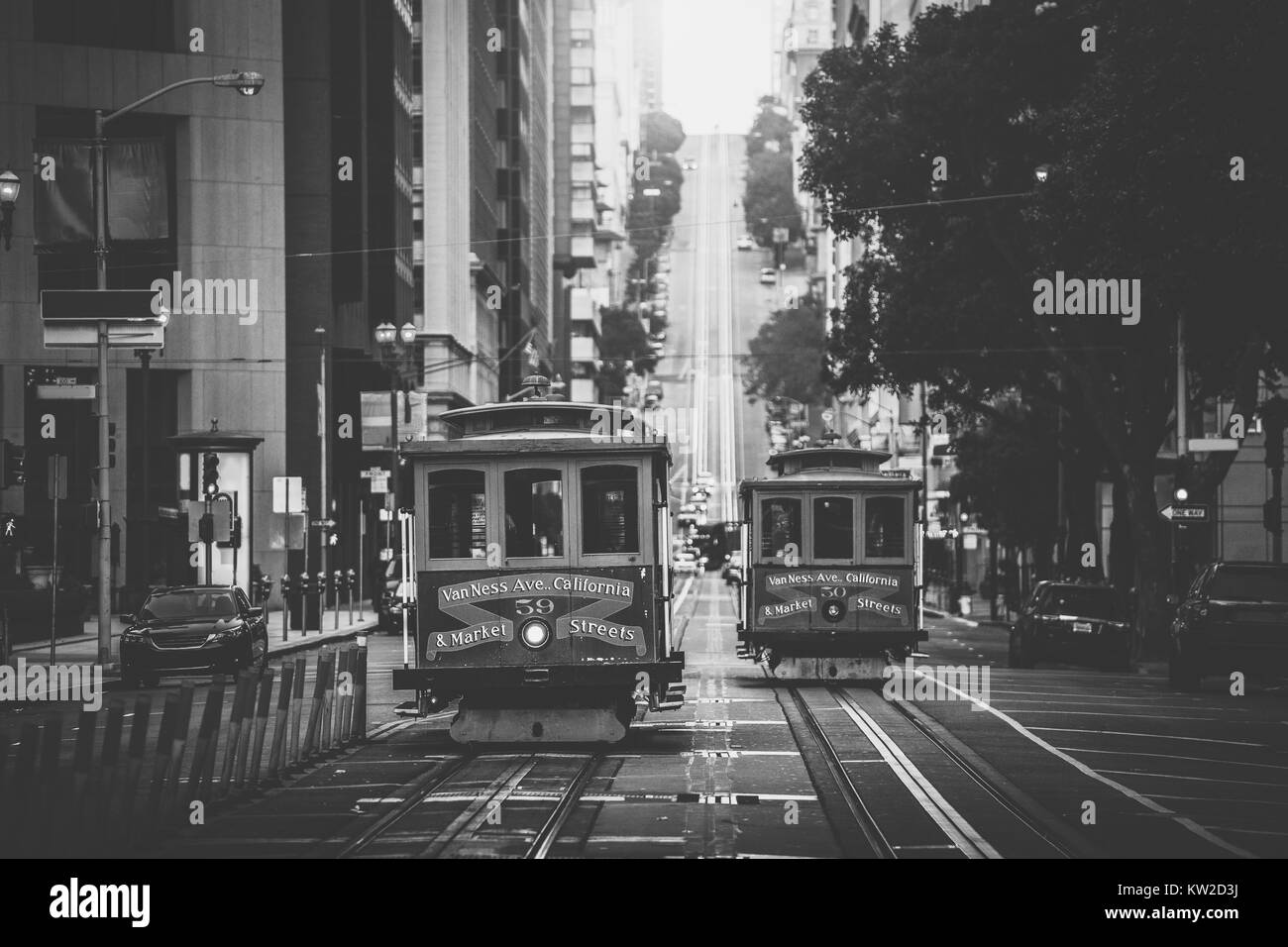 Classic view of historic traditional Cable Cars riding on famous California Street in beautiful morning light at sunrise in summer with retro vintage  Stock Photo