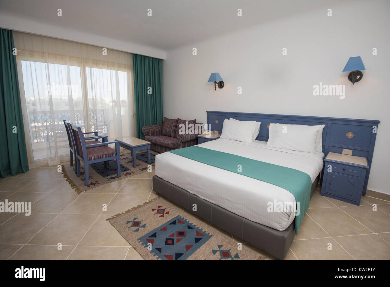 Double Bed In Suite Of A Luxury Hotel Room With Lounge And
