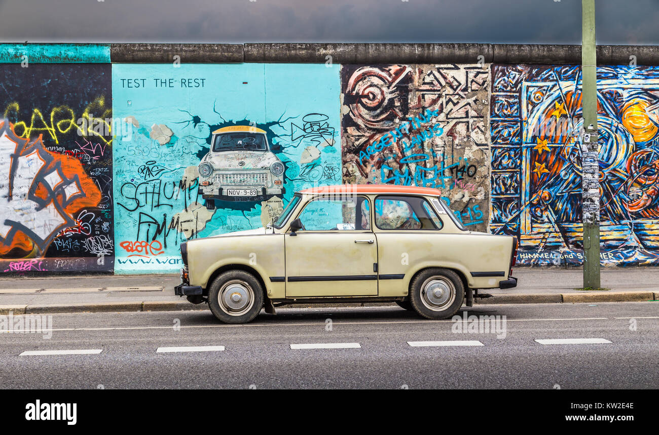 Famous Berliner Mauer (Berlin Wall) at East Side Gallery with an old Trabant, the most common vehicle used in East Germany, in front, Berlin Friedrich Stock Photo