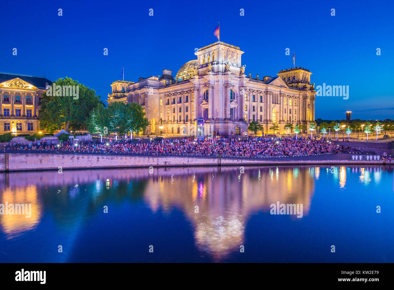 Panoramic view of famous Reichstag building, seat of the German Parliament (Deutscher Bundestag), with Spree river in twilight during blue hour Stock Photo