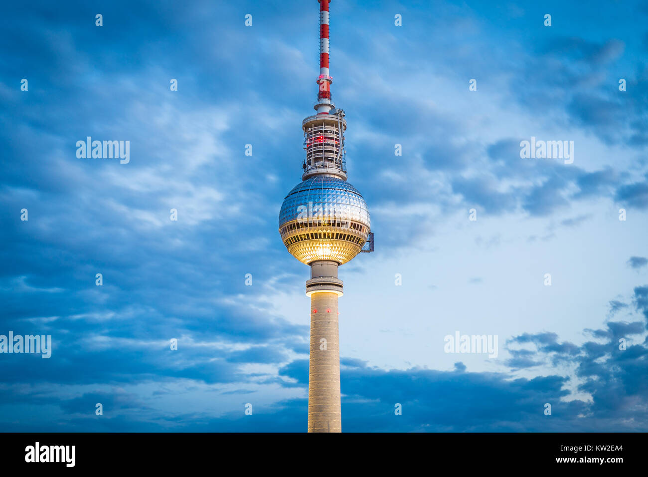 Aerial view of famous TV tower at Alexanderplatz with dramatic cloudscape in twilight during blue hour at dusk, Germany Stock Photo