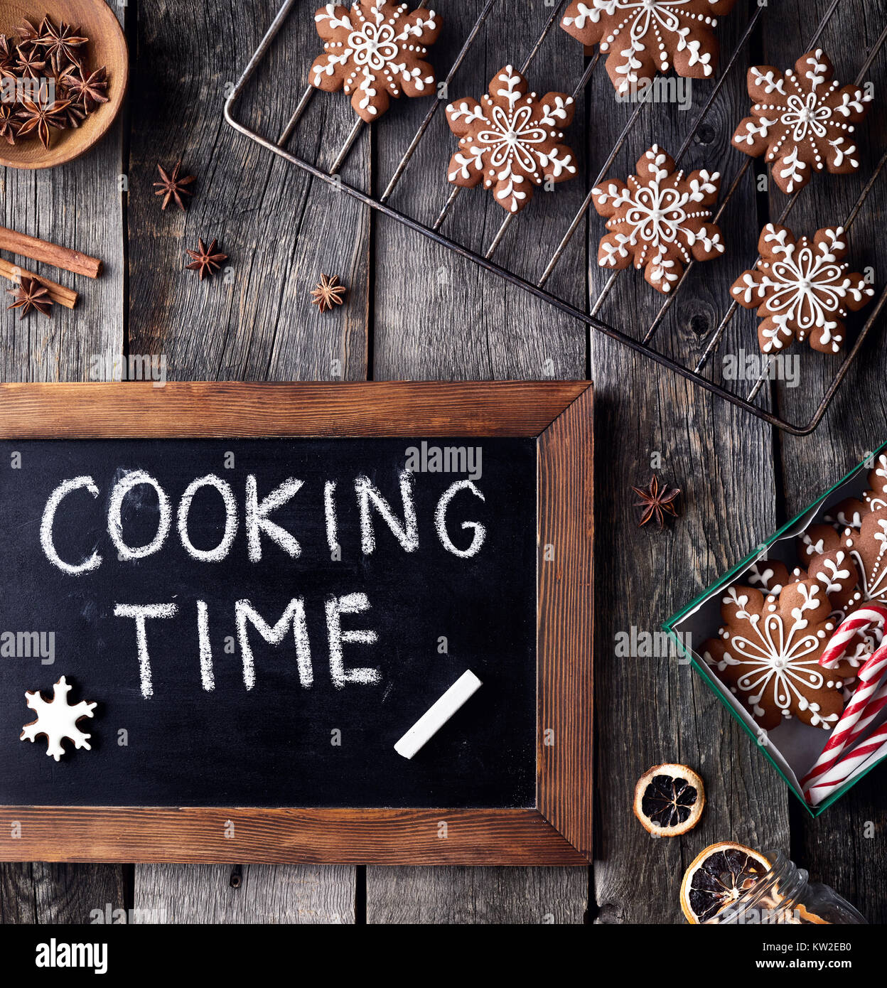 Cooking time for Christmas gingerbread stars on rustic wooden background Stock Photo