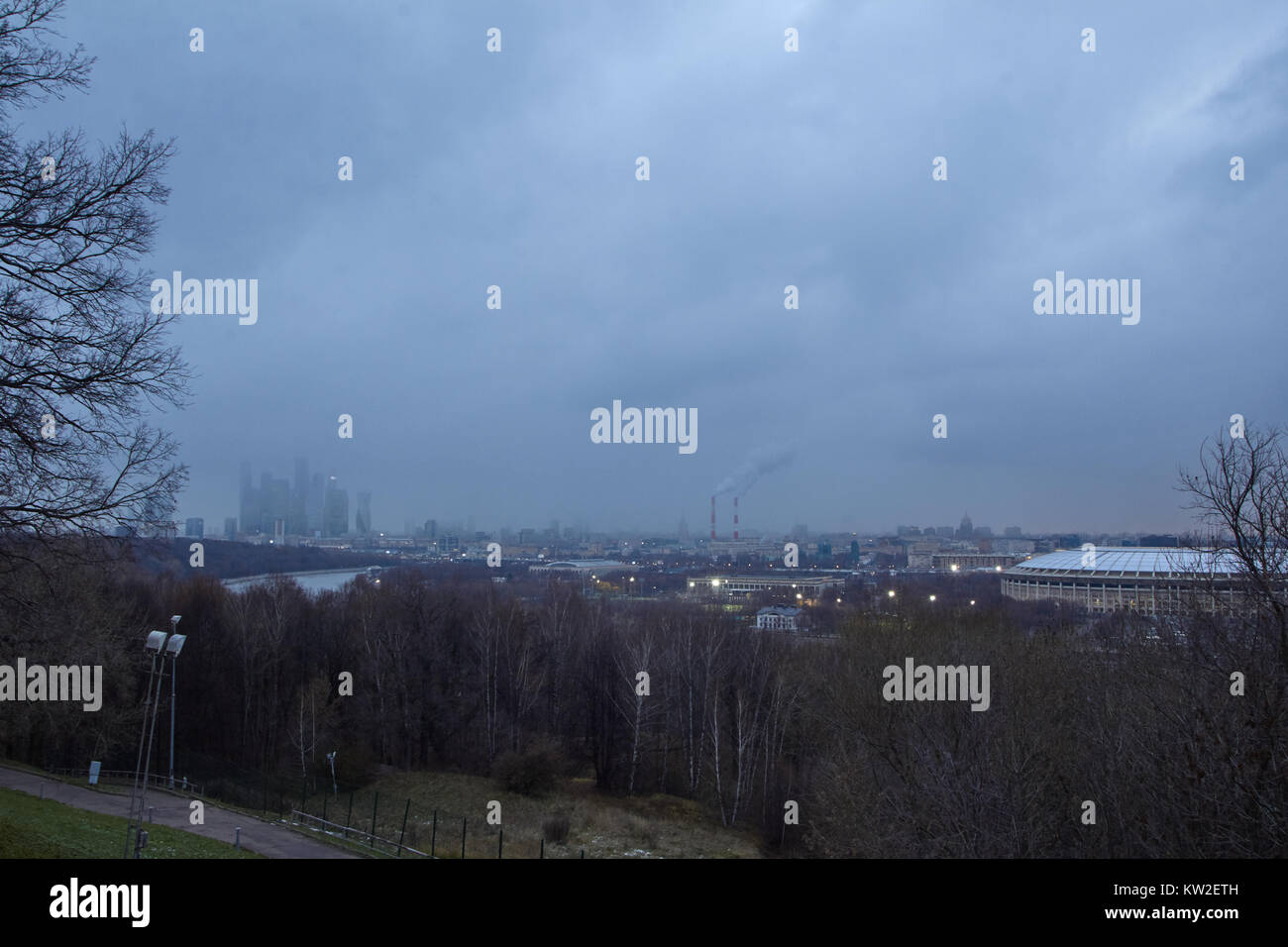 Cityscape at dusk with gloomy clouds at background Stock Photo