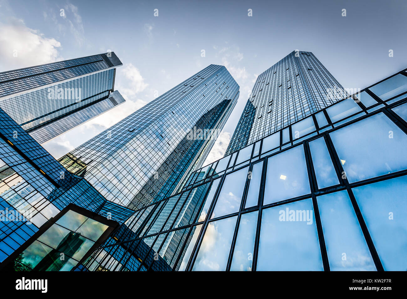 Bottom view of modern skyscrapers in business district against blue sky Stock Photo