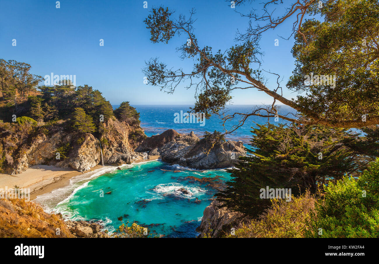 Classic postcard view of famous McWay Falls in scenic golden evening light at sunset, Pfeiffer Beach, Big Sur, California, USA Stock Photo